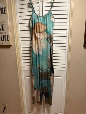 Turquoise Floral Jumpsuit w/ front pockets.